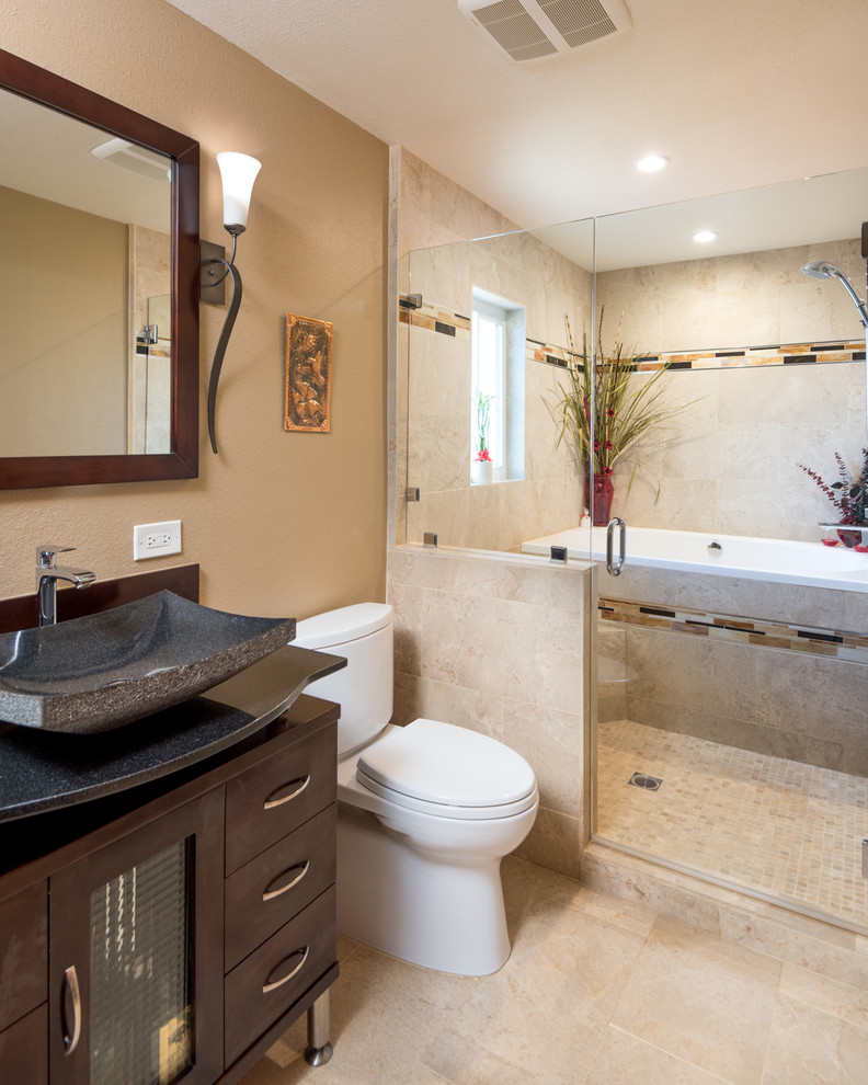 Design ideas for a large asian master wet room bathroom in San Diego with flat-panel cabinets, a japanese tub, a two-piece toilet, beige tile, ceramic tile, beige walls, a vessel sink, granite benchtops, dark wood cabinets, travertine floors, an open shower, black benchtops, a double vanity and a freestanding vanity.