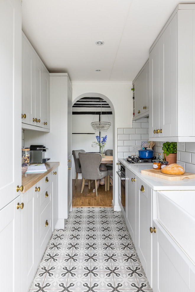 Design ideas for a country separate kitchen in Buckinghamshire with shaker cabinets, quartzite benchtops, ceramic splashback and ceramic floors.