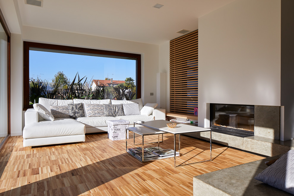 This is an example of a mid-sized contemporary living room in Other with white walls, light hardwood floors and multi-coloured floor.