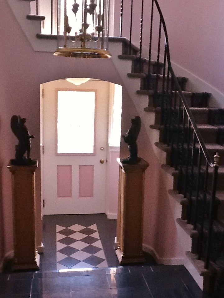 Example of a small eclectic carpeted ceramic tile front door design with carpeted risers and pink walls