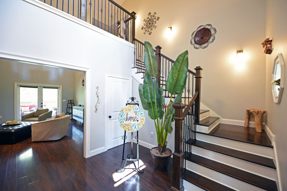 Photo of a large foyer in Atlanta with laminate floors, brown floor and vaulted.