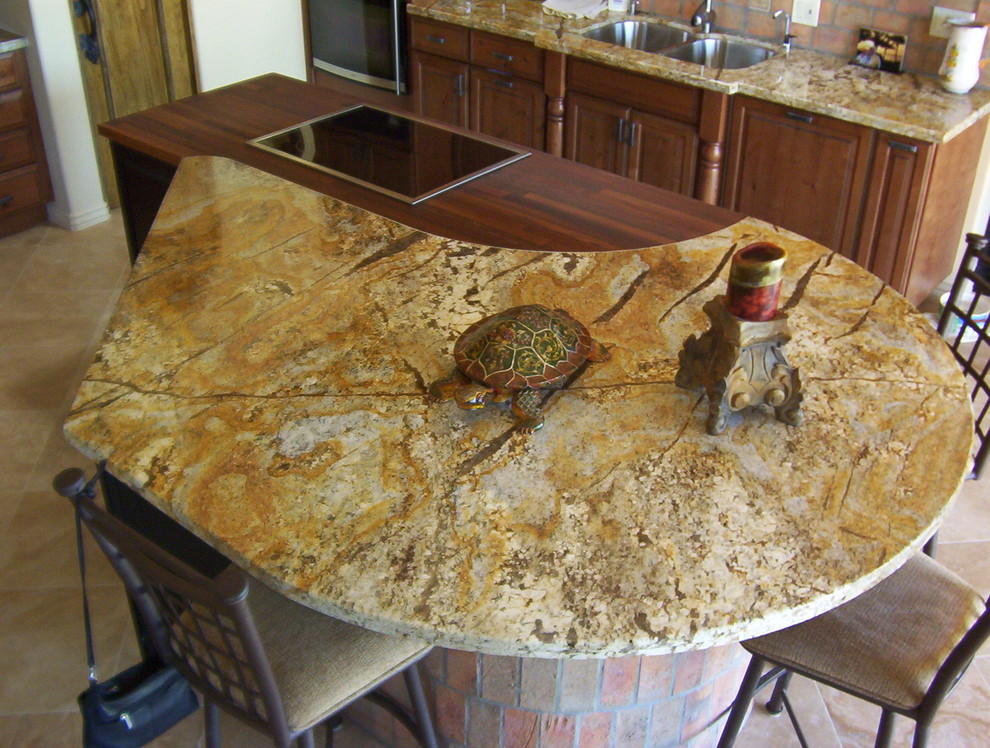 Example of a kitchen design in Phoenix with distressed cabinets, granite countertops and an island