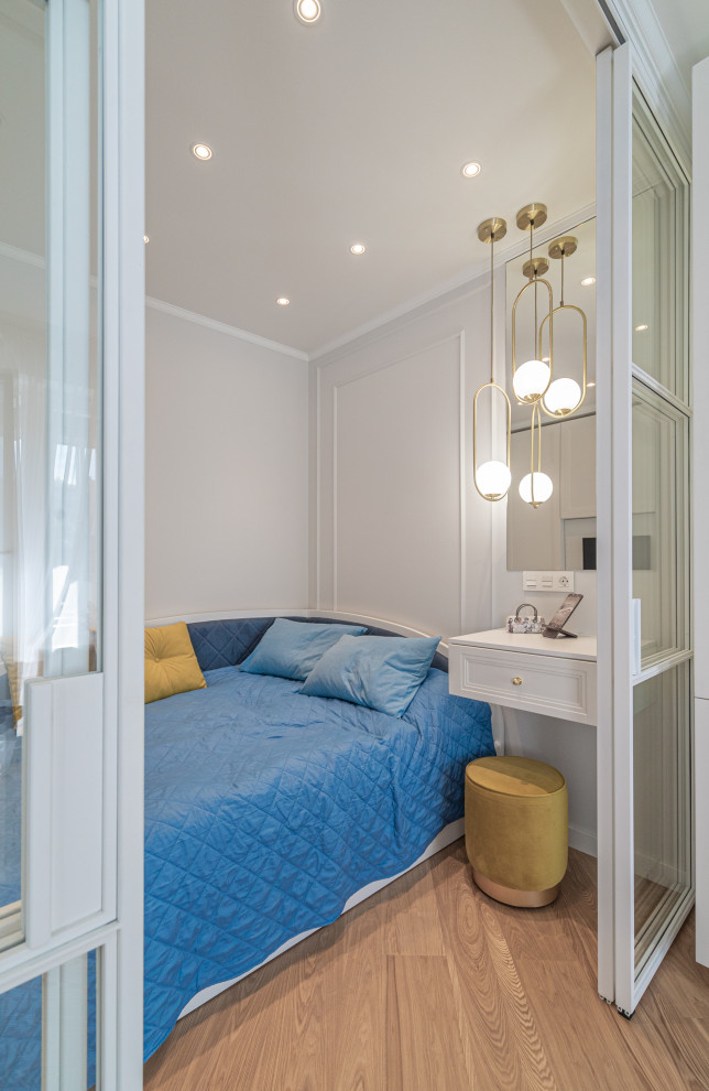 Bedroom - small traditional master medium tone wood floor bedroom idea in London with beige walls