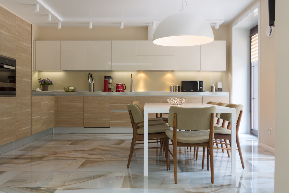 Inspiration for a contemporary l-shaped eat-in kitchen in Other with flat-panel cabinets, beige splashback, black appliances, no island and brown cabinets.