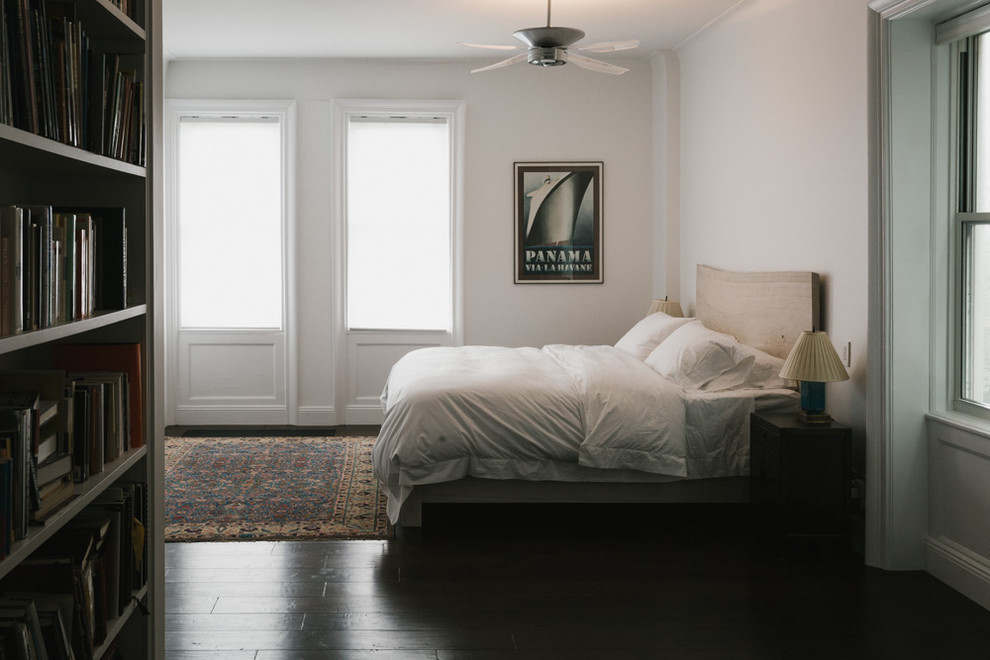 Design ideas for a mid-sized modern master bedroom in New York with white walls and dark hardwood floors.