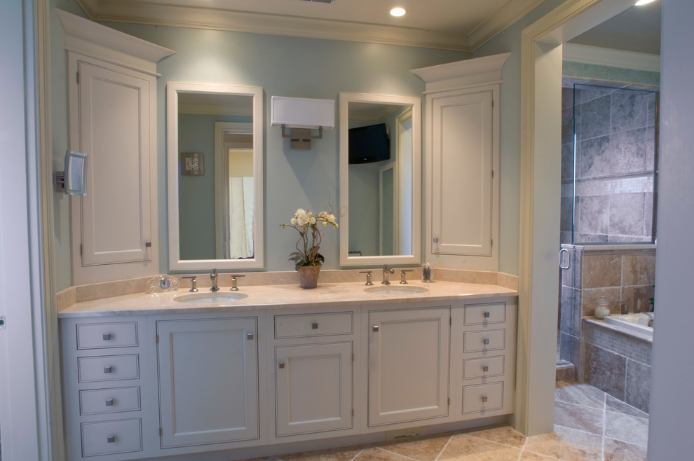 Mid-sized transitional master beige tile and stone tile limestone floor corner shower photo with an undermount sink, recessed-panel cabinets, white cabinets, marble countertops, a two-piece toilet and blue walls