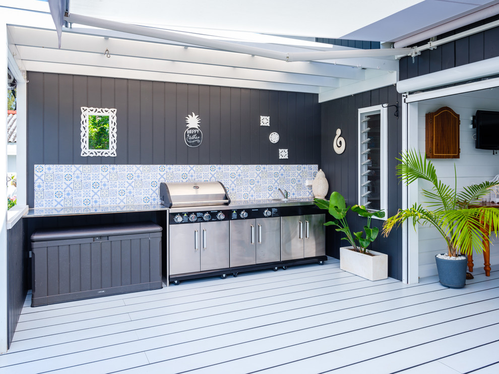 Photo of a large beach style backyard deck in Central Coast with an outdoor kitchen and an awning.