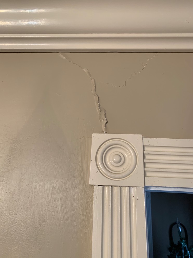 Persistent plaster cracks above doors and arches