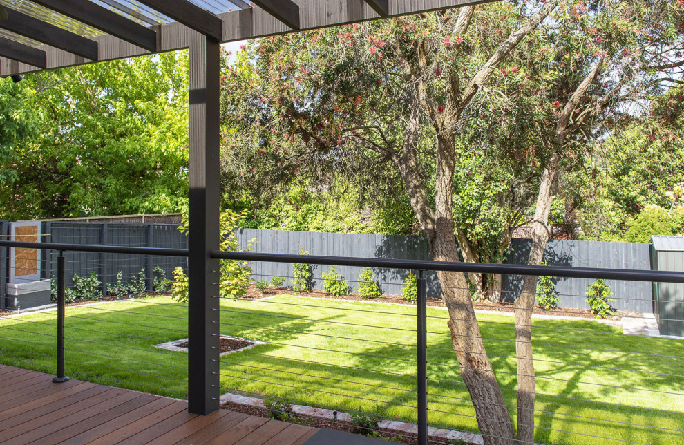 Inspiration for a large contemporary backyard ground level metal railing water fountain deck remodel in Melbourne with a pergola
