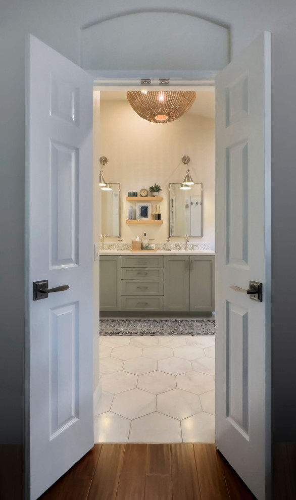 This is an example of a mid-sized beach style master bathroom in Orange County with shaker cabinets, green cabinets, a freestanding tub, a corner shower, green tile, mosaic tile, beige walls, marble floors, an undermount sink, engineered quartz benchtops, white floor, a hinged shower door, white benchtops, a shower seat, a double vanity, a built-in vanity and vaulted.