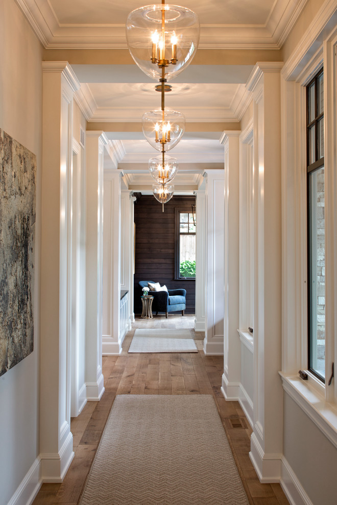 Expansive transitional hallway in Minneapolis with beige walls and medium hardwood floors.