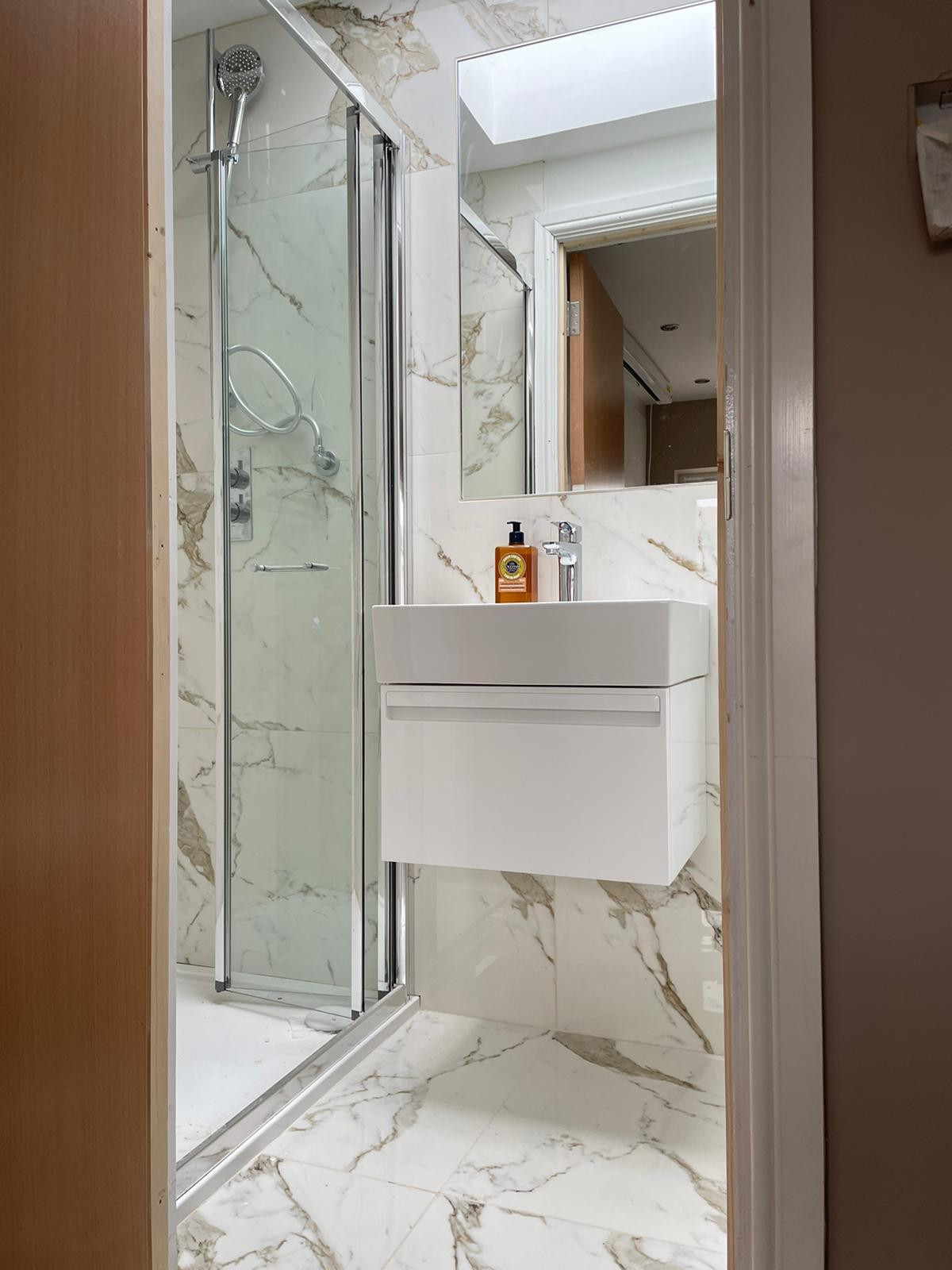 A compact vanity unit can help you to get everything neat and tidy even if the bathroom is quite small. A big bespoke mirror will make the difference for this kind of space.