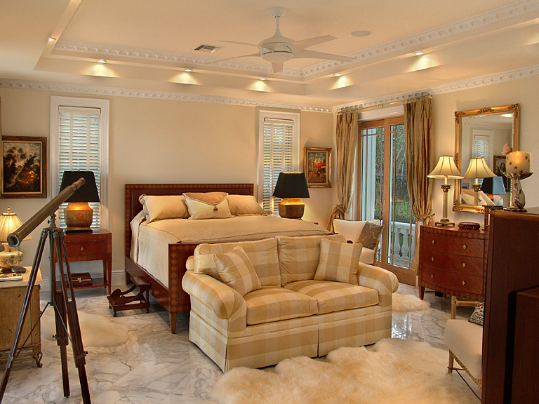 This is an example of a large traditional master bedroom in Miami with yellow walls and carpet.