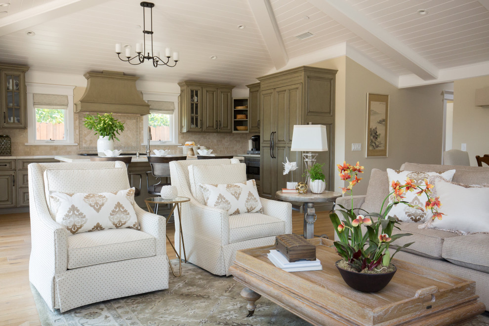 Traditional open concept living room in Santa Barbara with beige walls, light hardwood floors, beige floor, exposed beam, timber and vaulted.