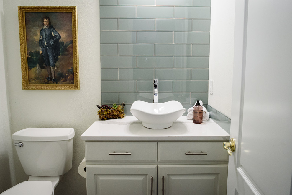 Bathroom - small transitional gray tile and glass tile bathroom idea in Denver with raised-panel cabinets, white cabinets, a two-piece toilet, white walls, a vessel sink and quartz countertops
