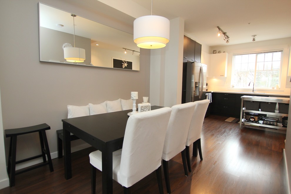This is an example of a modern kitchen/dining combo in Vancouver.