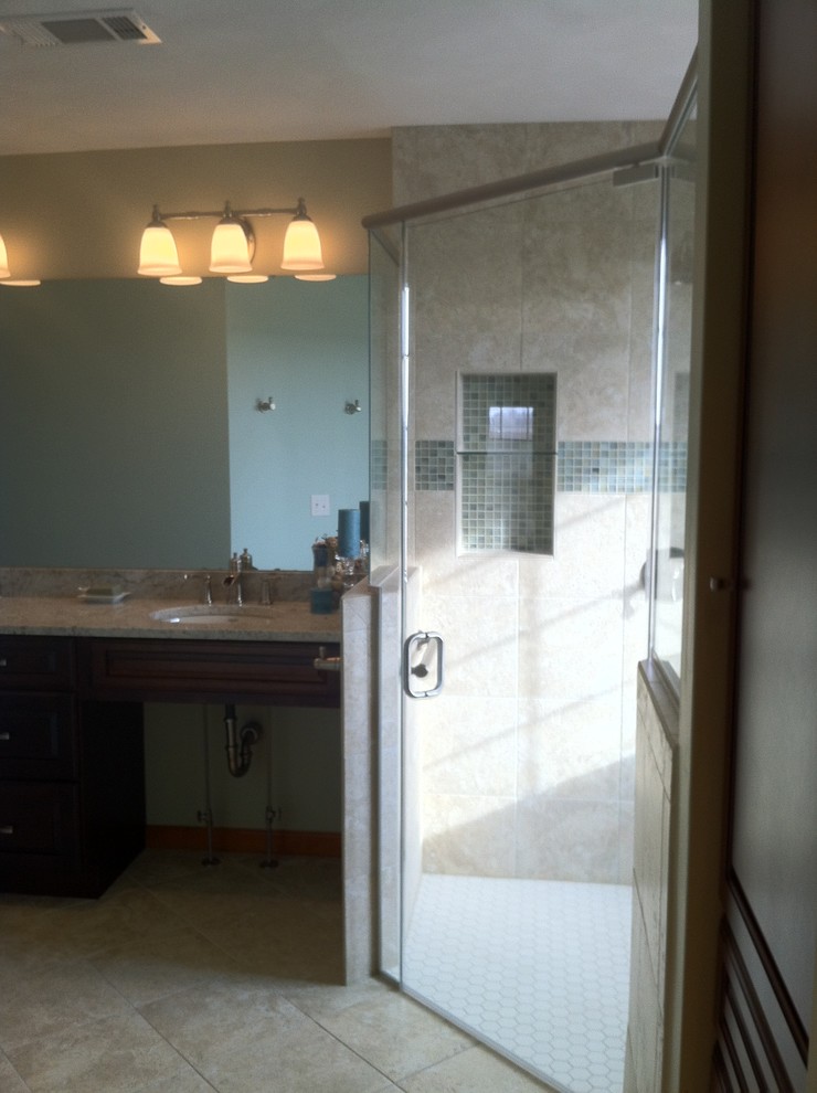 This is an example of a contemporary bathroom in St Louis with an undermount sink, raised-panel cabinets, dark wood cabinets, granite benchtops, a curbless shower, a two-piece toilet, beige tile and ceramic tile.