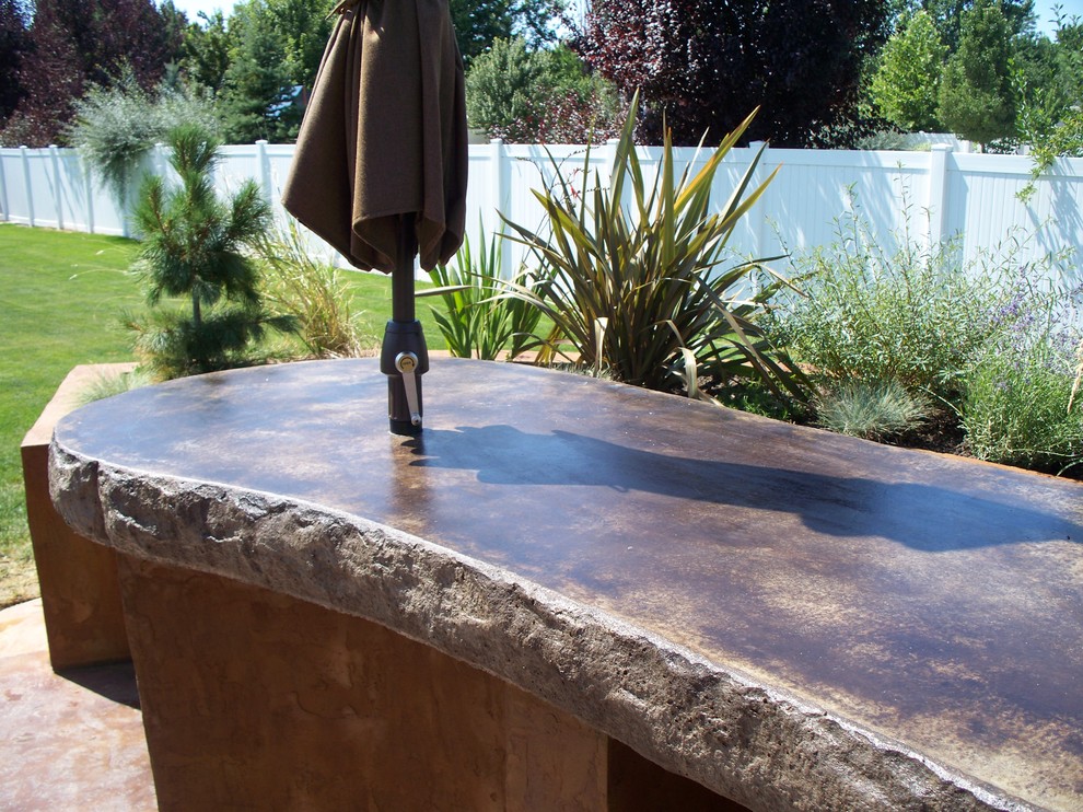 Mid-sized country backyard patio in Boise with an outdoor kitchen, concrete slab and no cover.