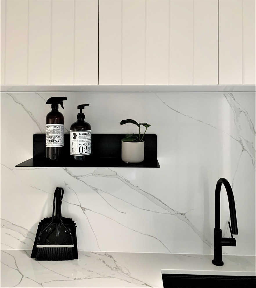 Inspiration for a contemporary porcelain tile laundry room remodel in Other with tile countertops and a side-by-side washer/dryer