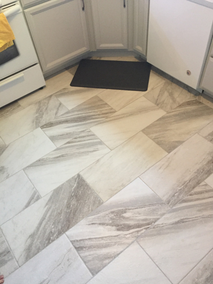 Example of a mid-sized transitional l-shaped ceramic tile and gray floor kitchen design in St Louis with an undermount sink, recessed-panel cabinets, gray cabinets, granite countertops, multicolored backsplash, glass sheet backsplash, white appliances and multicolored countertops