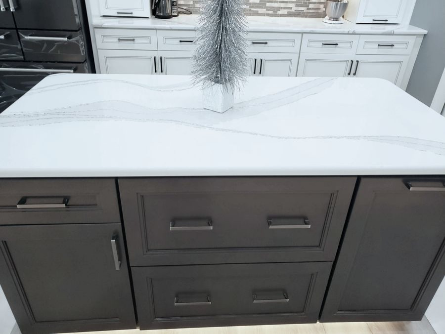 Example of a transitional u-shaped eat-in kitchen design with recessed-panel cabinets, white cabinets, quartz countertops, multicolored backsplash, mosaic tile backsplash, two islands and white countertops