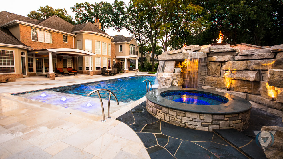 Inspiration for a large rustic backyard stone and rectangular natural pool fountain remodel in Chicago
