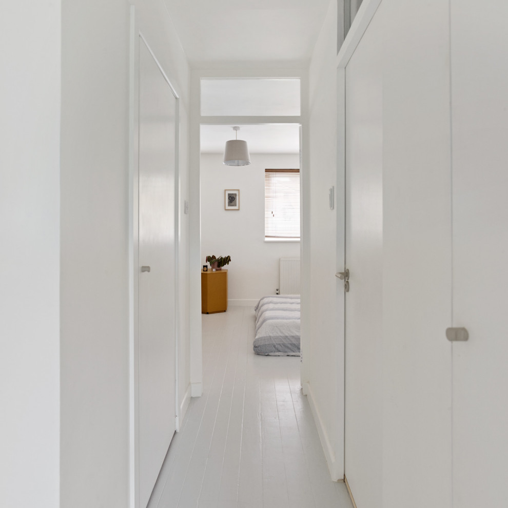 Стильный дизайн: маленький коридор в стиле модернизм с белыми стенами, деревянным полом и серым полом для на участке и в саду - последний тренд