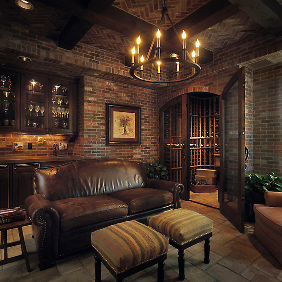 Large traditional wine cellar in Phoenix with terra-cotta floors.