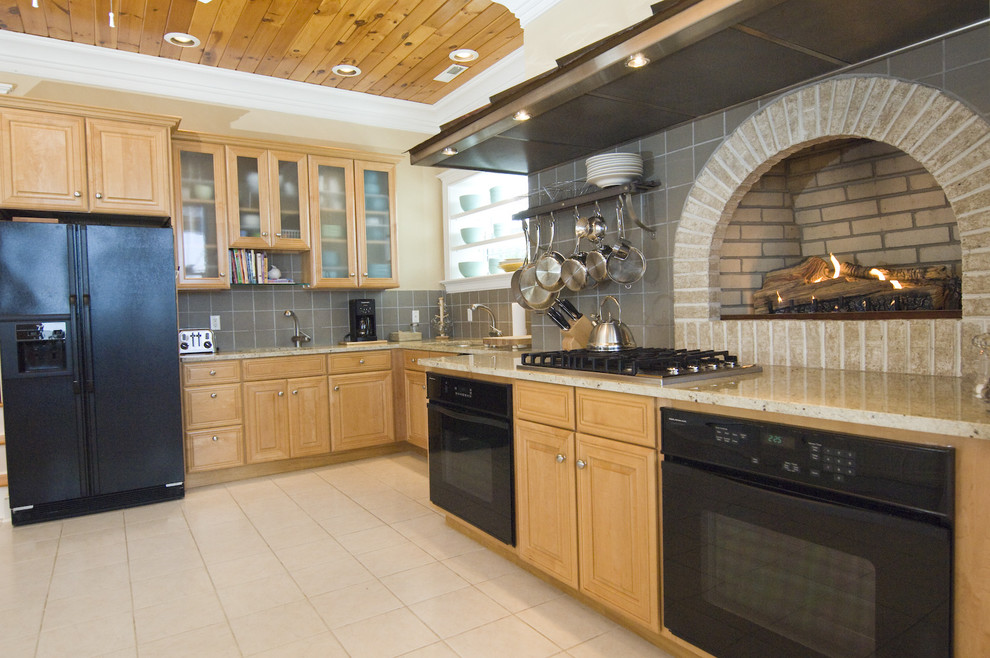 Design ideas for a traditional kitchen in Wilmington with glass-front cabinets, black appliances and grey splashback.