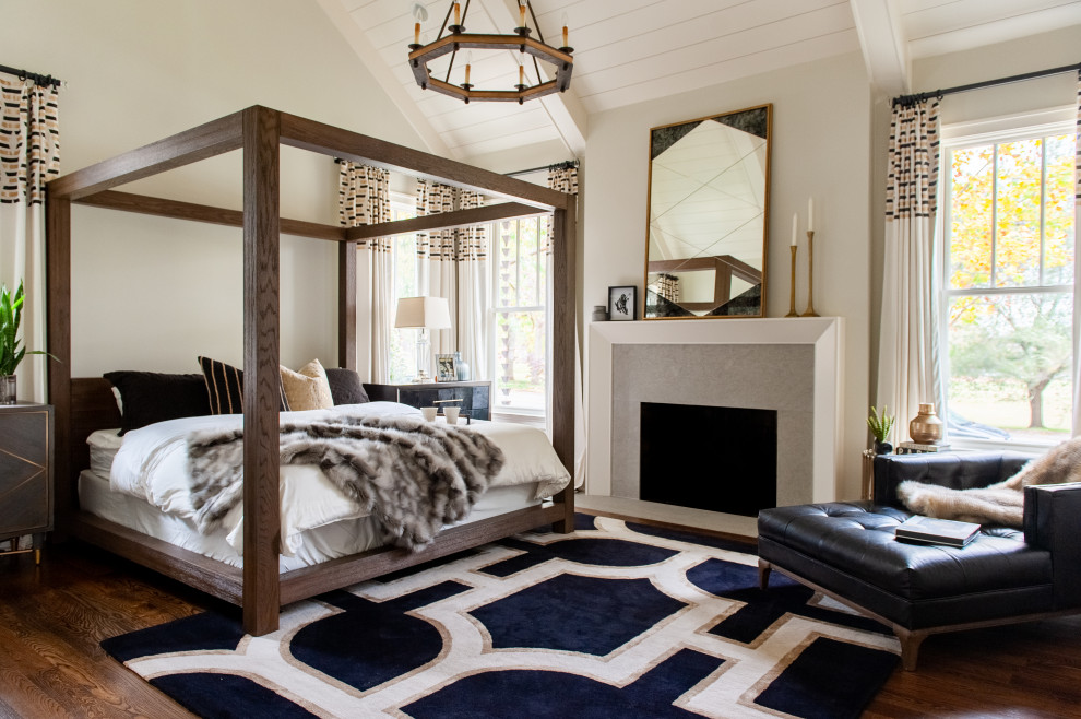 Design ideas for a country bedroom in Nashville with beige walls, dark hardwood floors, a standard fireplace, brown floor, exposed beam, timber and vaulted.