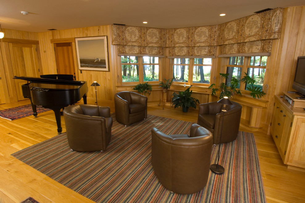 This is an example of a traditional enclosed family room in Boston with a music area, light hardwood floors and a freestanding tv.