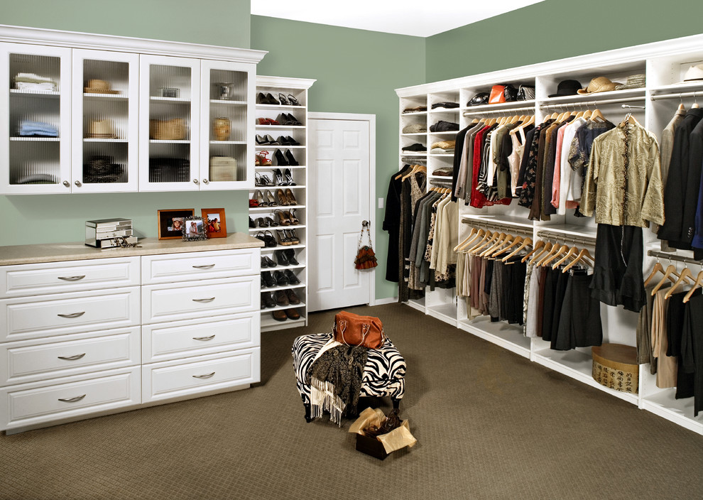 This is an example of a large traditional gender-neutral dressing room in San Francisco with white cabinets, carpet and beige floor.