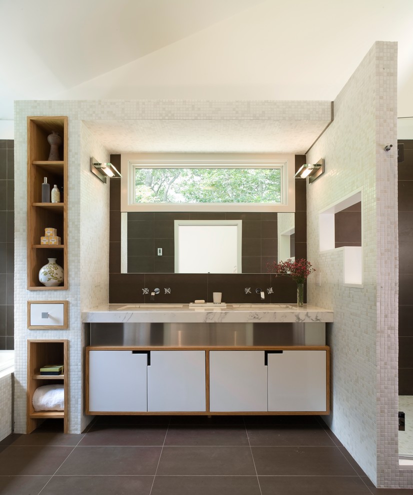 Mid-sized contemporary master bathroom in New York with open cabinets, light wood cabinets, mosaic tile, an undermount sink, marble benchtops, a drop-in tub, an alcove shower, a one-piece toilet, multi-coloured tile, multi-coloured walls and limestone floors.