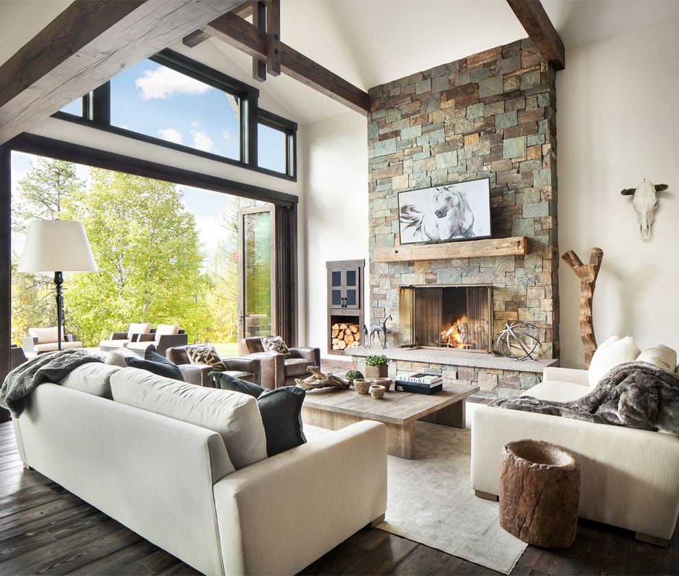 Photo of a country formal open concept living room in Other with white walls, dark hardwood floors, a standard fireplace and a stone fireplace surround.