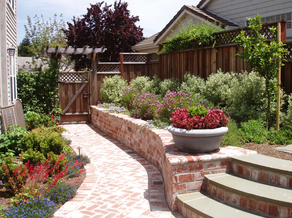 Inspiration for a mid-sized traditional backyard patio in San Francisco with brick pavers and no cover.