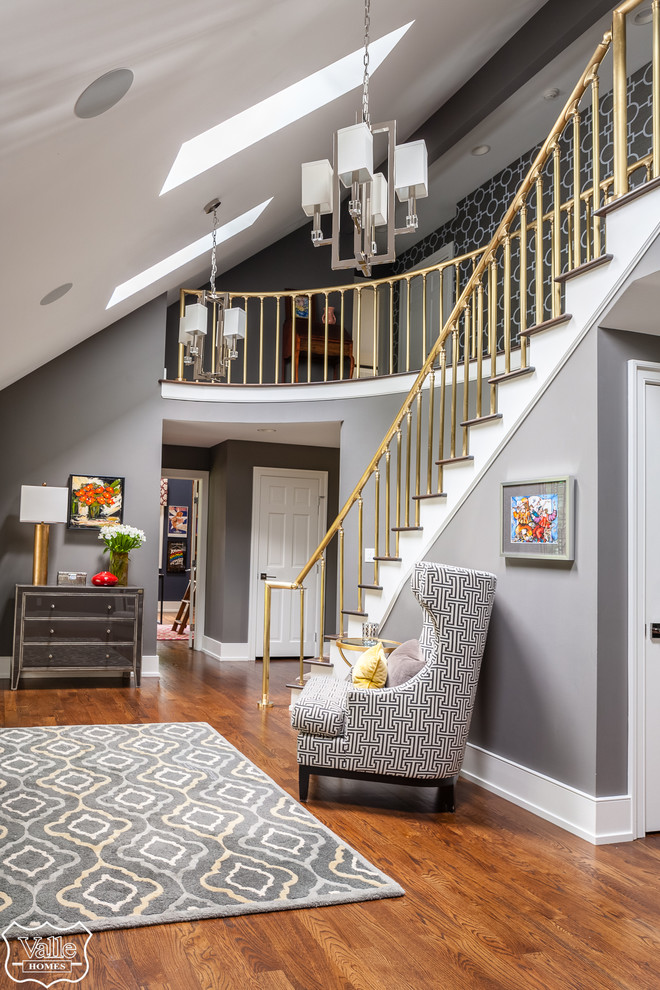 Example of a huge transitional medium tone wood floor and brown floor front door design with gray walls and a medium wood front door