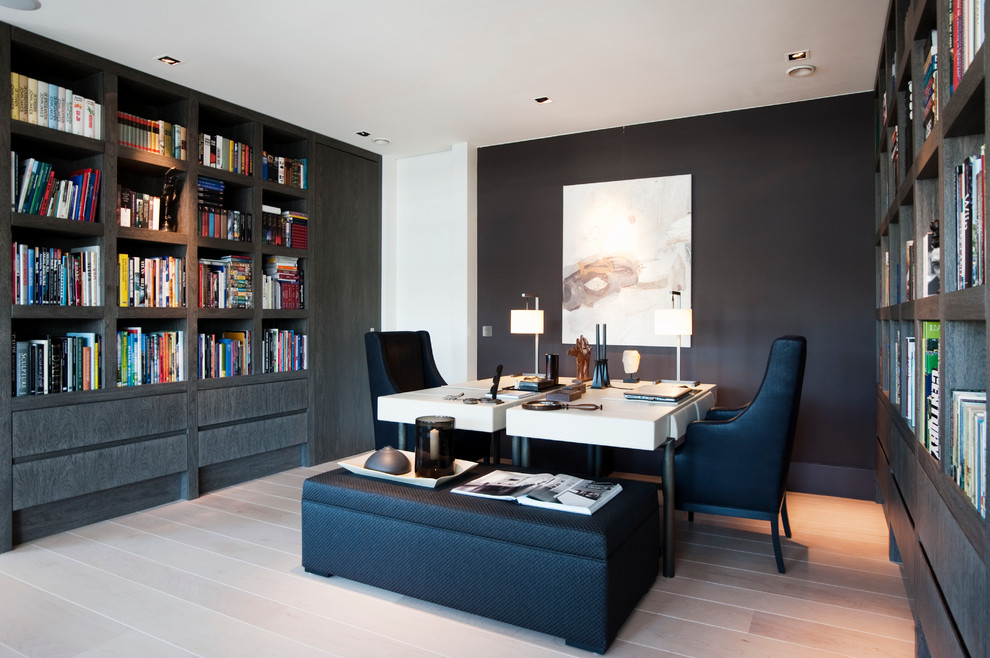 This is an example of a transitional home office in New York with a freestanding desk.