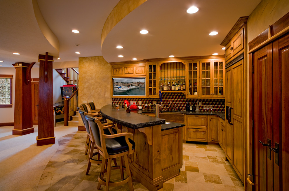 Photo of a mid-sized country u-shaped seated home bar in Chicago with raised-panel cabinets, medium wood cabinets, multi-coloured splashback and mosaic tile splashback.