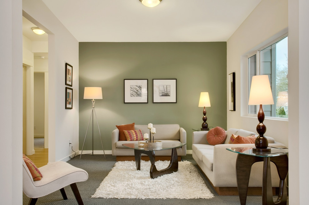 This is an example of a transitional enclosed living room in Seattle with green walls.