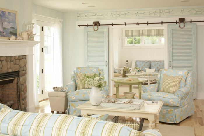 Coastal Living - Example of a mid-sized beach style open concept light wood floor and beige floor living room design in Tampa with white walls, a standard fireplace and a stone fireplace
