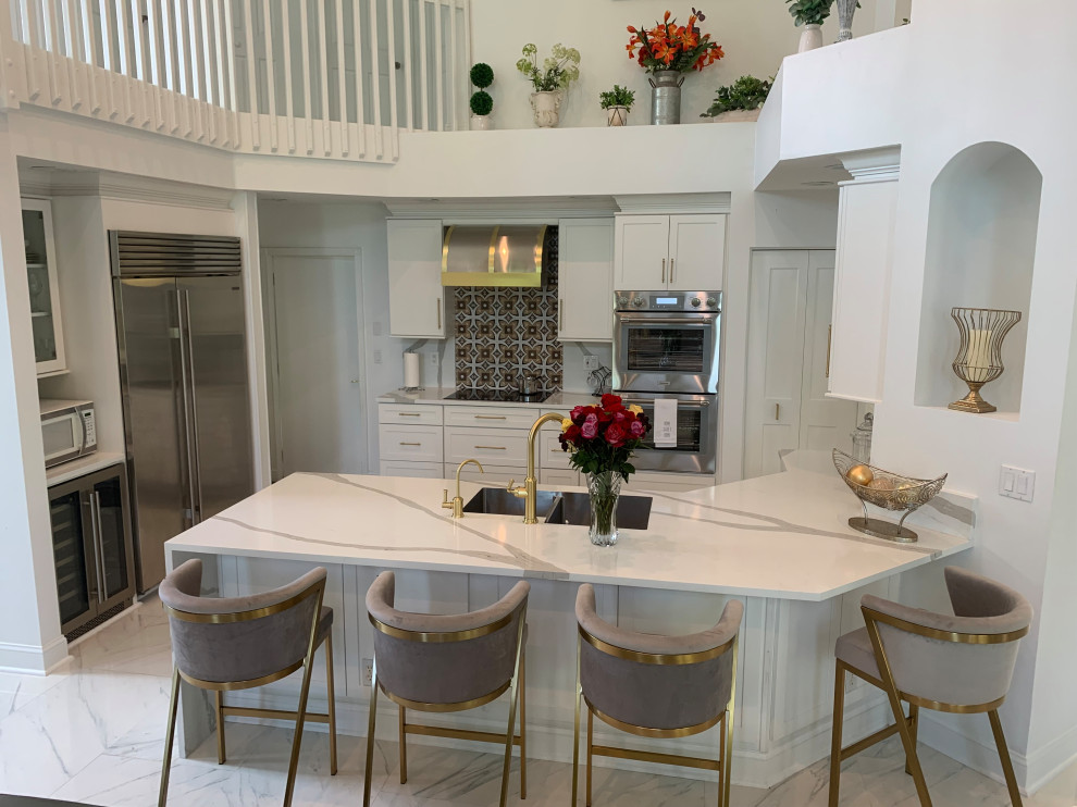 Exempel på ett klassiskt vit vitt kök och matrum, med en dubbel diskho, skåp i shakerstil, vita skåp, bänkskiva i kvarts, vitt stänkskydd, rostfria vitvaror, en halv köksö och grått golv