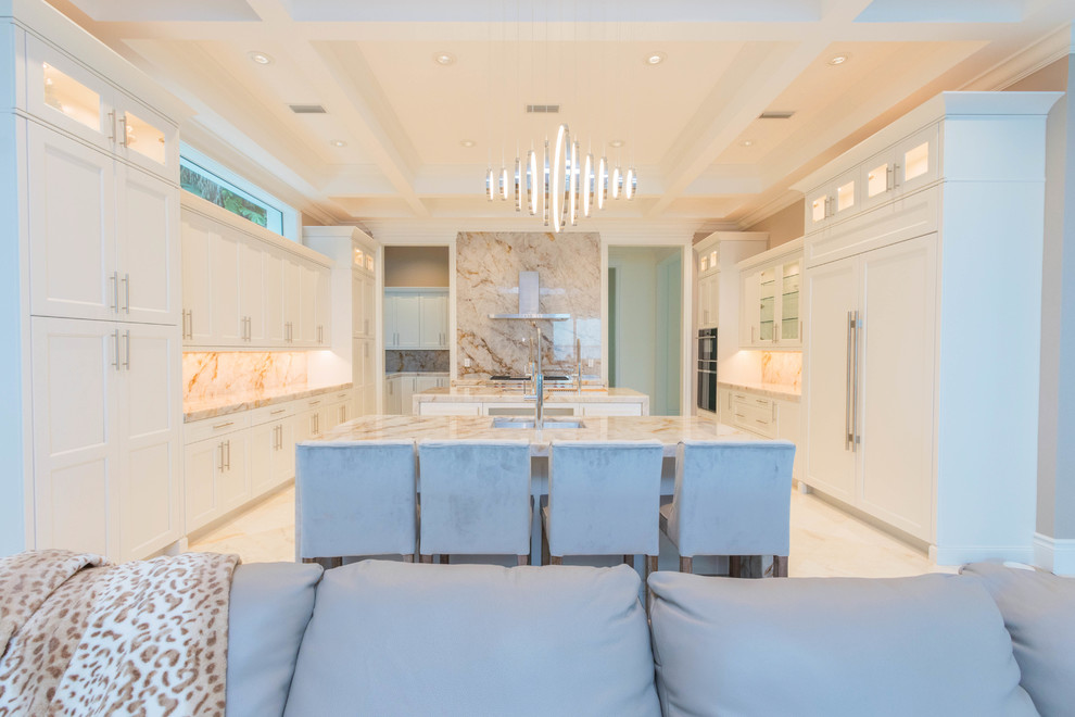 Open concept kitchen - huge transitional u-shaped marble floor and white floor open concept kitchen idea with an undermount sink, flat-panel cabinets, white cabinets, quartzite countertops, white backsplash, stone slab backsplash and two islands