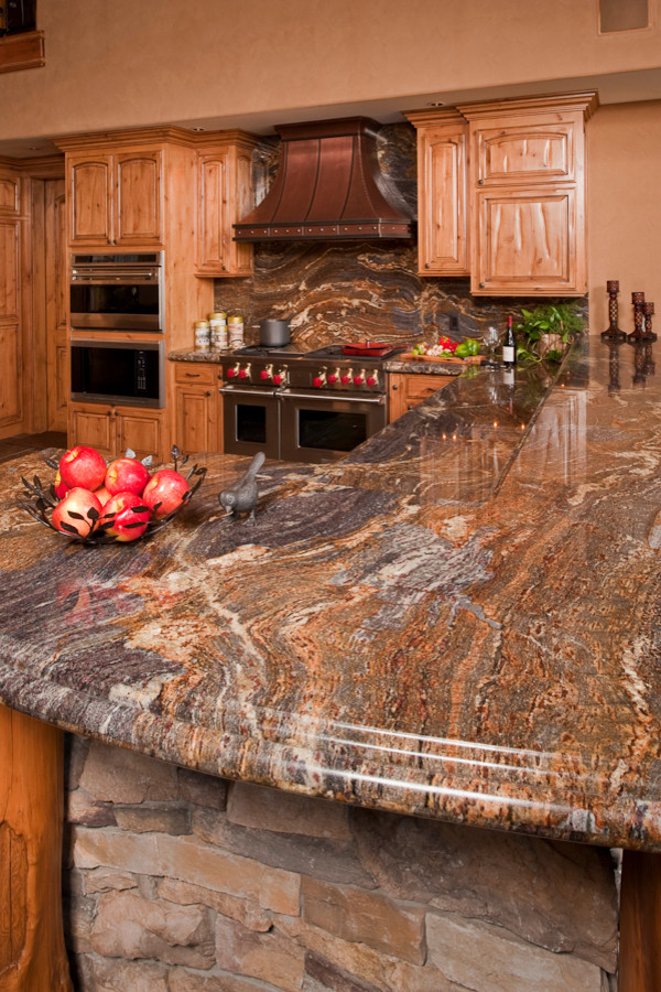 Open concept kitchen - huge rustic u-shaped slate floor open concept kitchen idea with an undermount sink, raised-panel cabinets, distressed cabinets, granite countertops, multicolored backsplash, stone slab backsplash, stainless steel appliances and a peninsula
