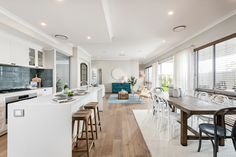 Photo of a beach style open plan dining in Perth with beige walls, medium hardwood floors and brown floor.