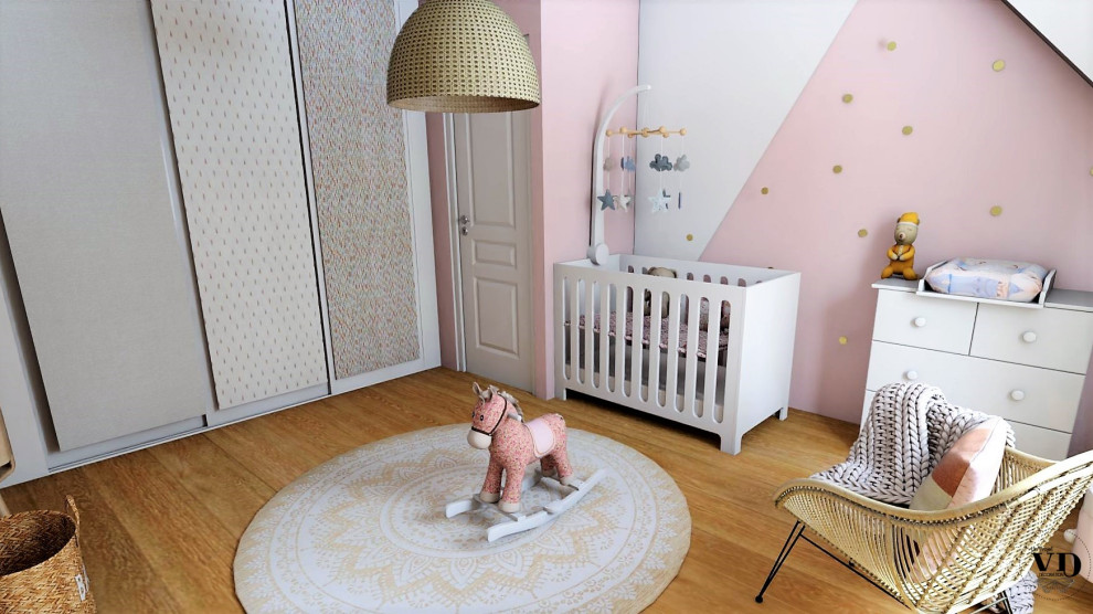 Medium sized scandinavian nursery for girls in Reims with pink walls and light hardwood flooring.