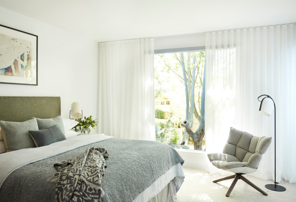 Mid-sized contemporary master bedroom in Melbourne with white walls, carpet and beige floor.