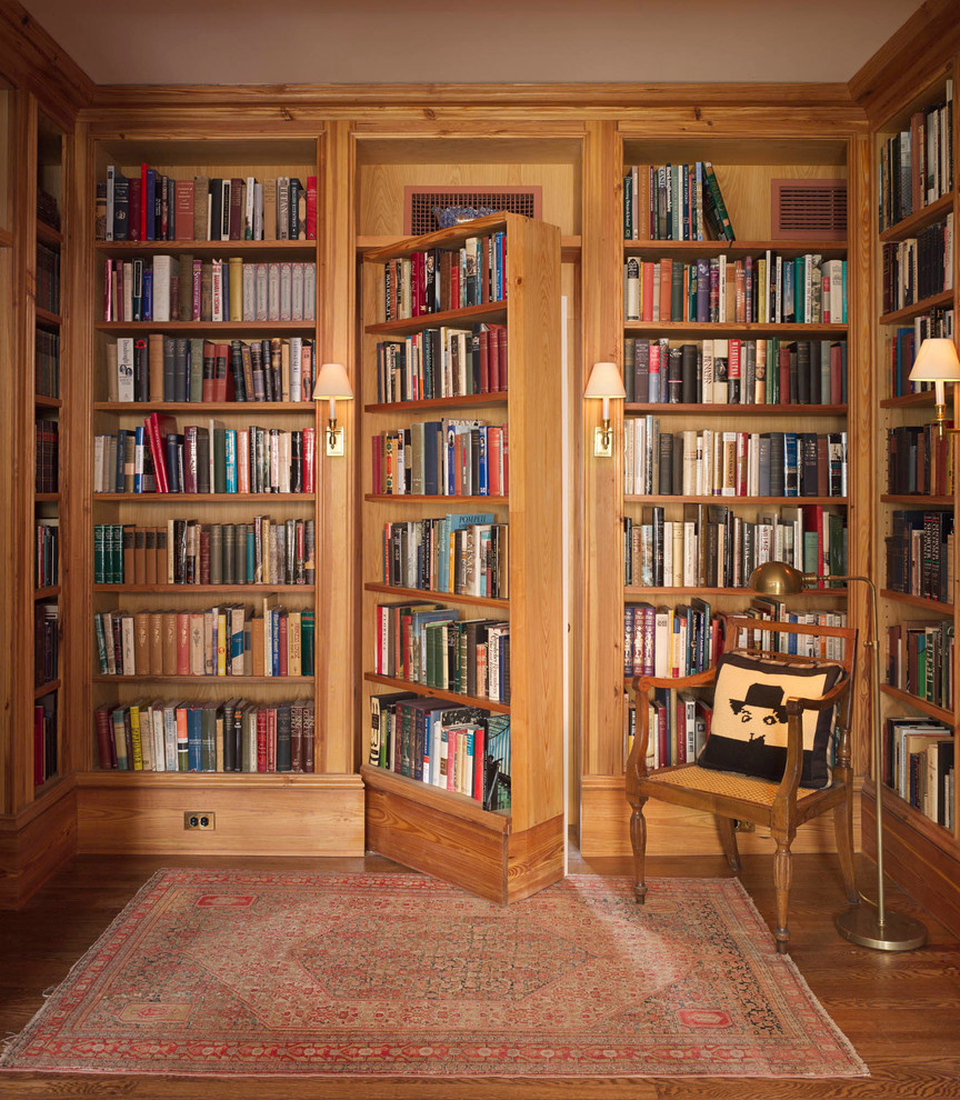 Design ideas for a traditional family room in New York with a library and medium hardwood floors.