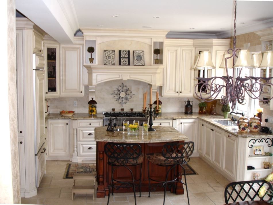 Photo of a large modern u-shaped eat-in kitchen in Toronto with an undermount sink, raised-panel cabinets, white cabinets, granite benchtops, beige splashback, stone tile splashback, stainless steel appliances, travertine floors and with island.