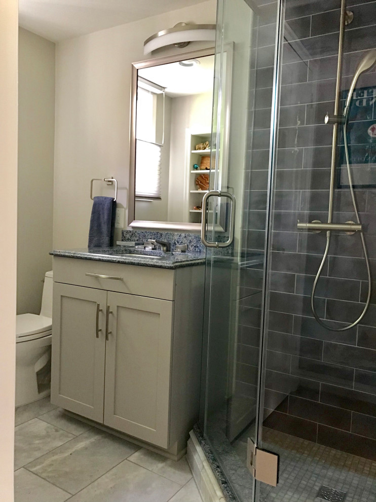 Inspiration for a mid-sized transitional master bathroom in DC Metro with recessed-panel cabinets, white cabinets, a corner shower, a one-piece toilet, blue tile, ceramic tile, beige walls, slate floors, a console sink, granite benchtops, grey floor, a hinged shower door and blue benchtops.