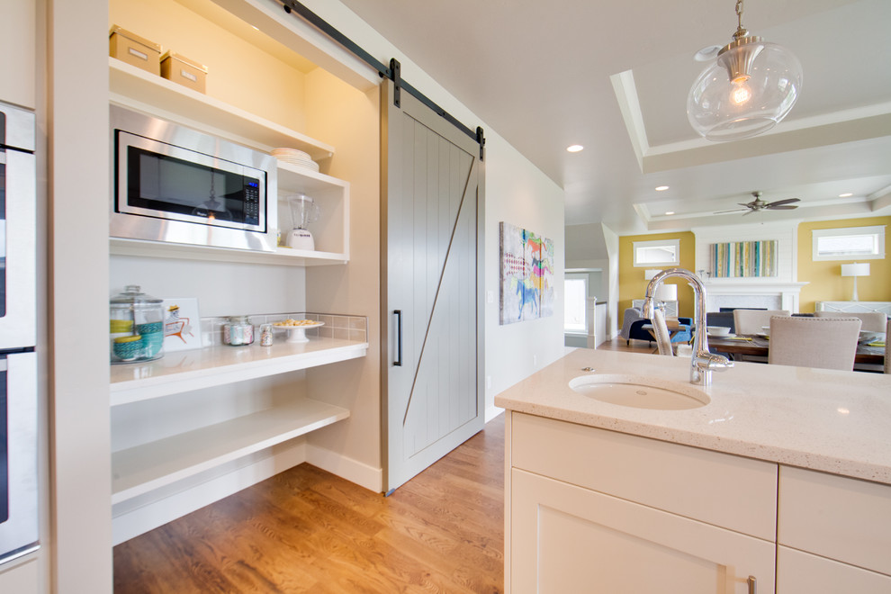 Large transitional light wood floor eat-in kitchen photo in Boise with shaker cabinets, white cabinets, quartzite countertops, stainless steel appliances and an island